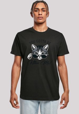 Schwarzes Baumwoll-T-Shirt mit einem Grafik eines Katers mit Sonnenbrille, darüber steht der Text "YOU GOTTA BE KITTEN ME!"