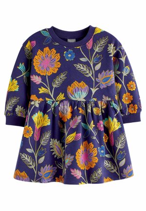 Robe en coton de couleur violet foncé avec un motif floral. Elle présente des manches longues, un col rond et une taille froncée, mettant en valeur des couleurs vives.