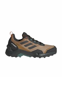 Black and brown hiking shoe with mesh upper, three black stripes, textured rubber sole, and a red pull tab at the heel for easy wear.
