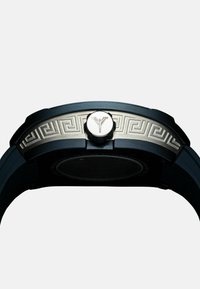 Black watch with a round case, silver accents, and an engraved Greek key pattern on the bezel. Features a prominent crown on the side.