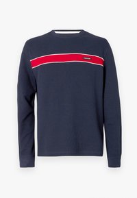 Tumesinise varrukatega pikkade varrukatega särk soonilise tekstuuriga, millel on horisontaalne punane triip ja valged aktsendid rinna kohal ning logomärgistusega.