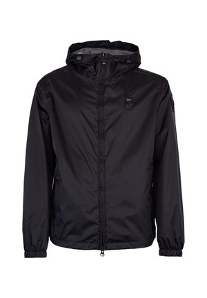 Veste à capuche zippée noire avec poignets élastiques, poches avant, et petit patch jaune et noir sur la poitrine et la manche.