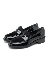 Black leather loafers with patent and suede finishes. Rounded toe, low block heel, and decorative band across the instep.