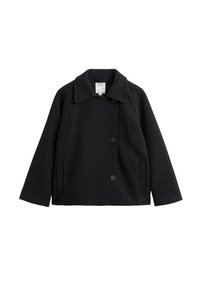 Svart ullrock med notched krage, raglanärmar, framknappar och sidfickor; slät textur och enkel design.