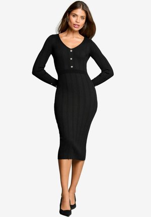 Musta ribbed midi-mekko, jossa on pitkät hihat, V-pääntie ja koristeelliset napit edessä. Muotoon ommeltu siluetti, jossa on sileä tekstuuri.