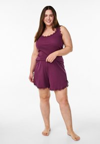 Purple cotton sleep set featuring a sleeveless top with lace trim and matching shorts with scalloped edges. Smooth texture, relaxed fit.