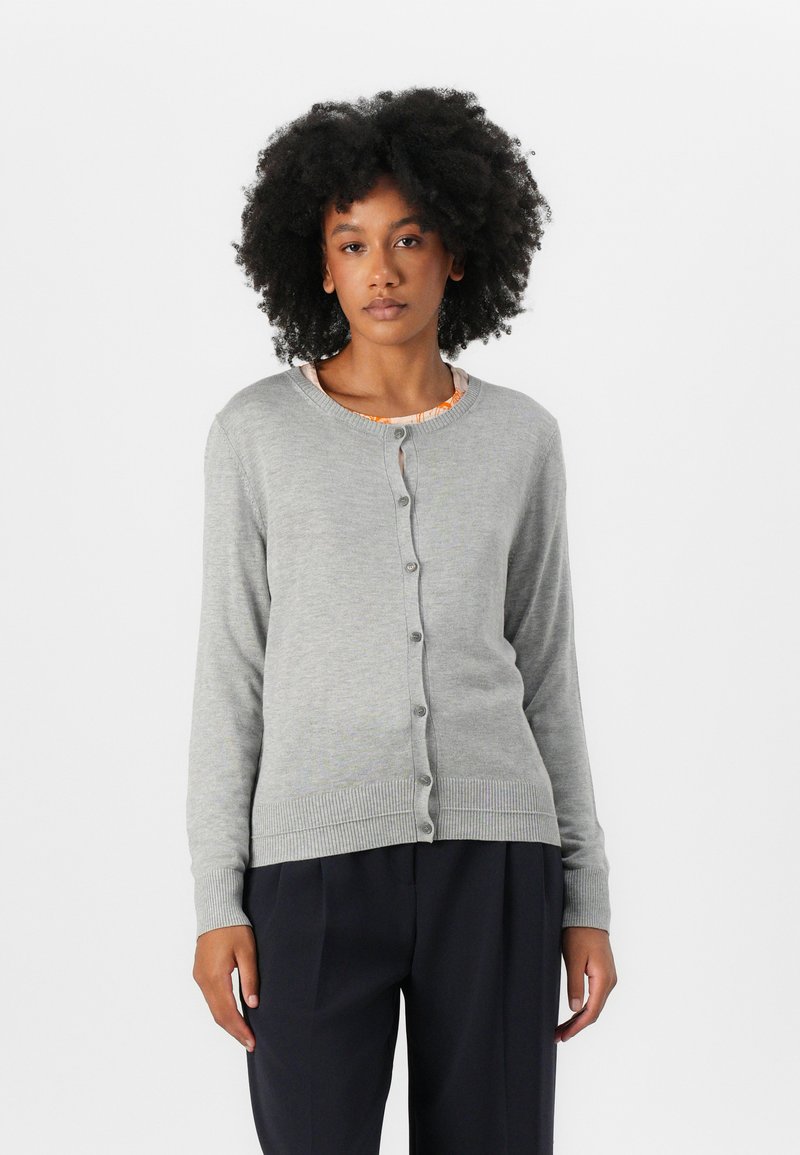 Gray button-up cardigan made of soft knit fabric, featuring a round neckline, ribbed cuffs, and hem. Worn over a patterned top.