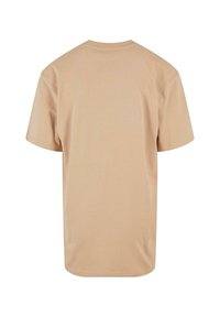 Beige, short-sleeved t-shirt made of soft fabric. Features a round neckline and a relaxed fit with a straight hem at the bottom.