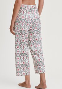 Patroon katoen broek met een elastische tailleband. Bevat bloemmotieven in roze, groen en blauw op een lichte achtergrond. Verkorte lengte.