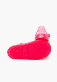 Pink rubber sandal with a textured sole, adjustable strap, and cut-out design. Size marked as 24. Features logo "igor" on the side.