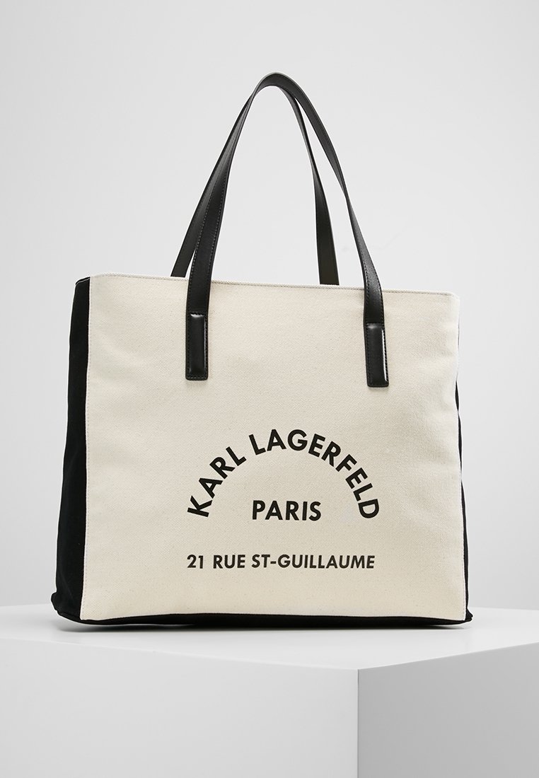 Torba płócienna z czarnymi akcentami, z wyraźnym napisem: "KARL LAGERFELD PARIS 21 RUE ST-GUILLAUME." Dwie mocne czarne uchwyty.