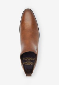 Brown leather chelsea boot with a rounded toe, elastic side panels, pull tab, and a textured interior in dark purple with gold detailing.