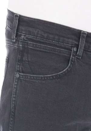 Zwarte denim jeans met een klassiek 5-pocket ontwerp, een middelhoge taille en zichtbare stiksels langs de naden.