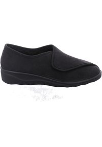 Scarpa nera slip-on con tomaia in tessuto morbido, punta arrotondata e cuciture sottili. Presenta una suola in gomma bassa e testurizzata per garantire aderenza.