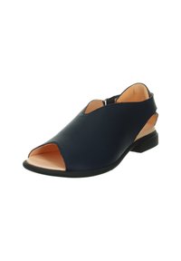 Open-toed navy leather shoe with a low heel, featuring a cutout design and contrasting tan interior. Bottom has a textured black sole.