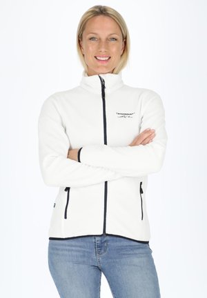 White fleece jacket with a high collar, navy zip, and side pockets. Features a logo on the left chest and black trim along the edges.