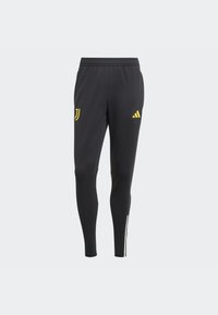 Schwarze Sporthose aus glattem Material mit gelben Akzenten. Mit einem Kordelzugbund und weißen Seitenstreifen ausgestattet. Zeigt ein Logo auf der Vorderseite.