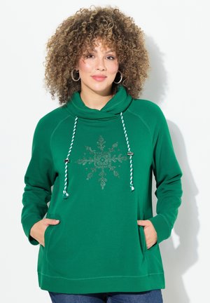 Grüner Pullover mit Kapuze. Mit weißen und grünen Kordeln und einem Schneeflockendesign. Inklusive Fronttaschen und gerippten Bündchen.