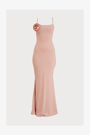Pink, form-fitting gown with spaghetti straps and a decorative flower accent on the left shoulder, featuring smooth, stretch fabric and a floor-length design.