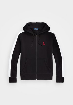 Black zip-up hoodie with white stripes on sleeves, front pockets, drawstring hood, and red Polo Ralph Lauren logo on chest.