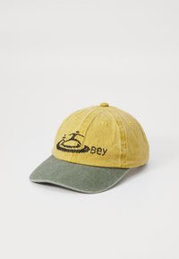 Yellow and green cotton cap with embroidered black logo and text, curved brim, and six-panel design, featuring a textured finish.
