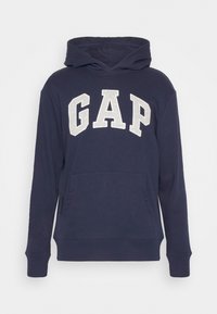 Mörkblå huvtröja med framficka och stora vita "GAP"-bokstäver över bröstet.