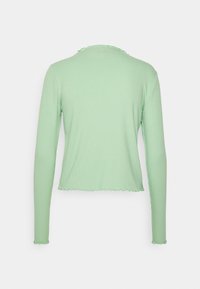 Dlouhá tealová top s ribovanou texturou, zvlněným výstřihem a lemem, navržený pro přiléhavý střih.