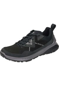 Scarpa sportiva nera con tomaia in mesh e suede, suola in gomma testurizzata, design con lacci e dettaglio del logo distintivo sul lato.