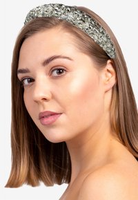Crystal-embellished headband featuring rectangular and round beads in silver and clear tones, with a smooth band and textured accents.