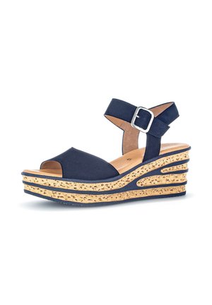 Navy blue wedge sandal with cork-patterned sole, ankle strap with silver buckle, open toe, and cushioned tan insole on white background.
