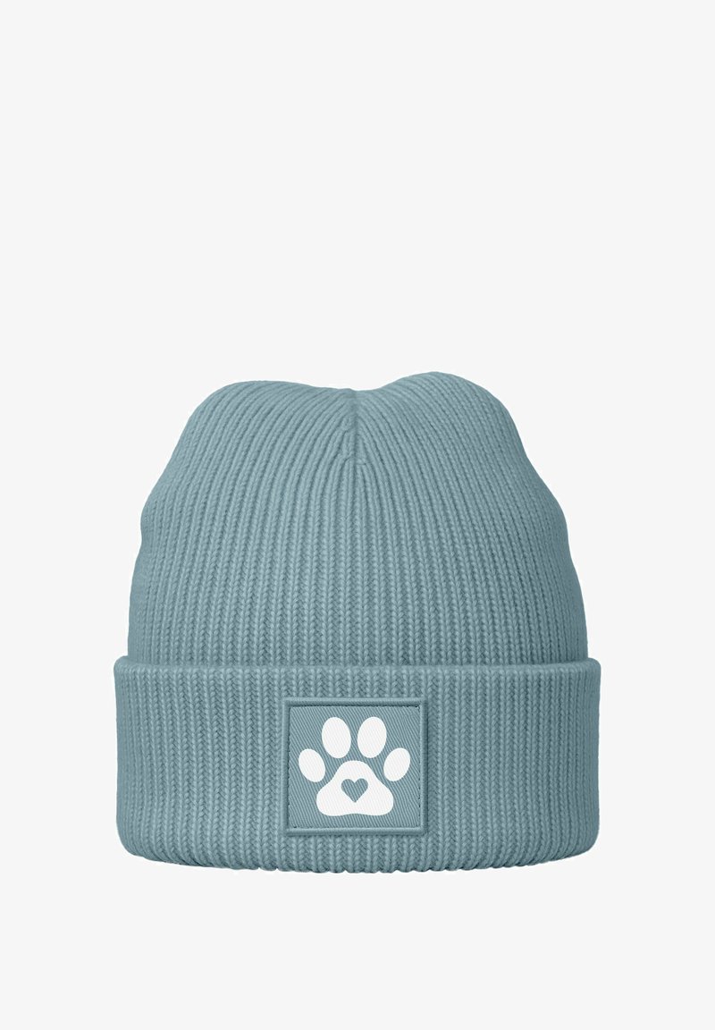 Cable knit beanie in light blue with a ribbed design. Features a square patch with a white paw print and heart motif.