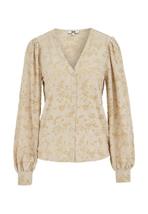 Beige Bluse mit V-Ausschnitt, floraler Spitzenmusterung, Knopfleiste und aufgepufften Ärmeln. Weicher Stoff mit strukturierter Oberfläche und detaillierten Akzenten.