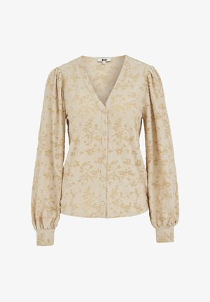 Beżowa bluzka z dekoltem w kształcie litery V, kwiatowym wzorem z koronki, zapinana na guziki z przodu oraz z bufkami na rękawach. Miękka tkanina o fakturowanym wykończeniu i szczegółowych akcentach.