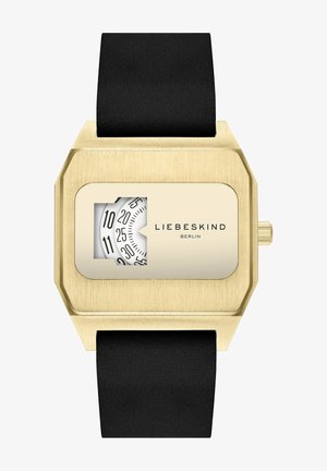 Orologio rettangolare dorato con cassa texture, cinturino in silicone nero e quadrante bianco con numeri neri, che presenta il logo "LIEBESKIND BERLIN".