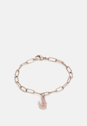 Rose gold chain bracelet with elongated links and a textured charm resembling a hand, adorned with pink rhinestones.