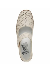 White leather shoe with cutout pattern, rounded toe, velcro strap, and textured sole. Includes printed brand logo and cushioned insole.