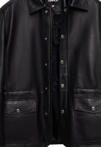 Black leather jacket with a buttoned front, snap pockets, and a lined interior. Features a classic collar and smooth texture.