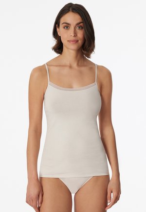 Beige camisole with thin adjustable straps, featuring a delicate lace trim along the neckline, made of soft, smooth fabric.