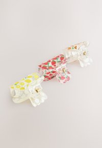 Three small transparent hair clips with spring hinges, each decorated with lemon, strawberry, and orange fruit patterns.