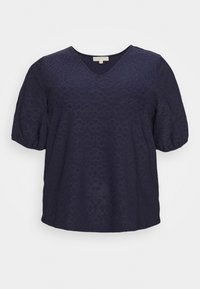 Námořnickomodrý top s výstřihem do V a krátkými objemnými rukávy, s texturovaným květinovým vzorem a volným střihem. Materiál vypadá lehce a prodyšně.