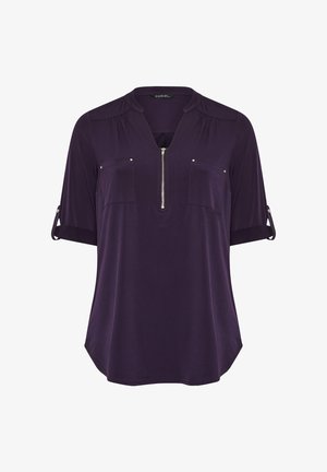 Lila Bluse mit kurzen Ärmeln und halbem Reißverschluss, zwei Brusttaschen, hochrollbaren Ärmeln, aus weichem, glattem Stoff mit lässiger Passform.