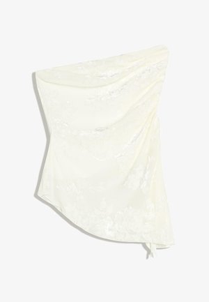 Asymmetrical white silk skirt with subtle floral jacquard pattern and draped detailing on one side.