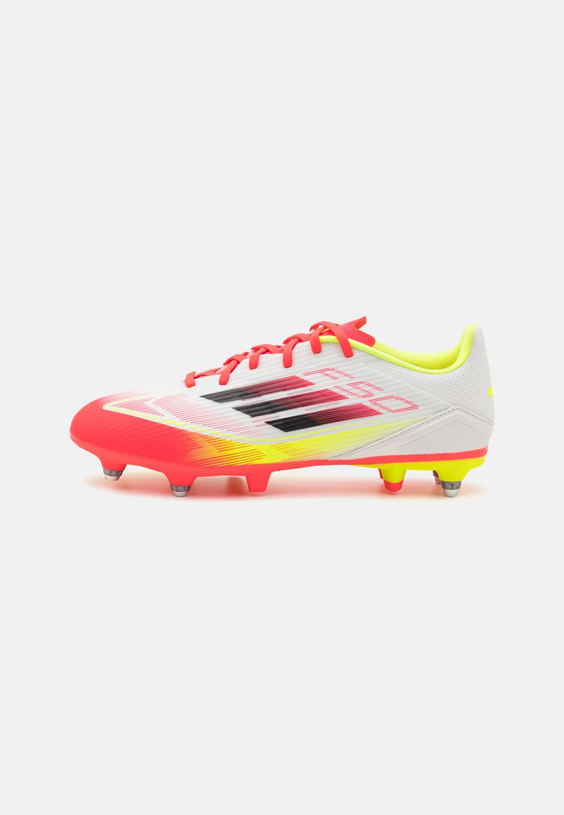 White soccer cleat with pink gradient and yellow accents, featuring a textured surface, red laces, and six studs on the outsole.