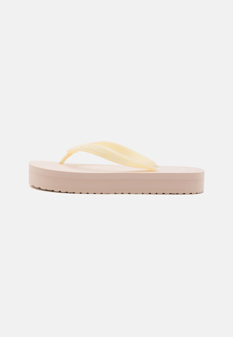 Yellow flip-flop with a textured pink sole. Features a smooth strap and embossed branding on the strap. Lightweight design.