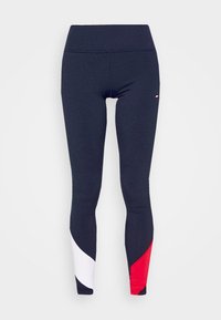 Marina leggings med en åtsittande design, med vita och röda böjda sidodetaljer. Slät textur med hög midja.