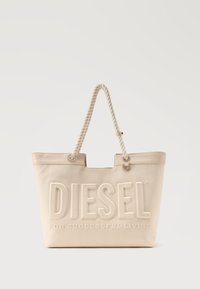 Μπεζ τσάντα tote από καμβά με λαβές από στριφτό σχοινί και ανάγλυφο λογότυπο "DIESEL For Successful Living" στο μπροστινό μέρος.