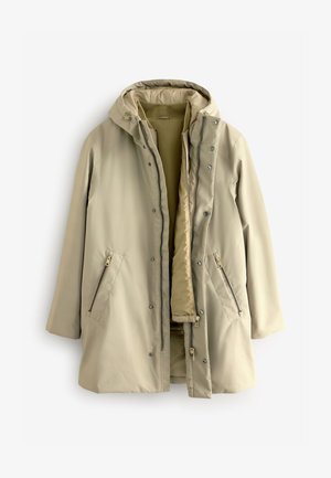 Bež jakna otpornna na vodu s kapuljačom, koja ima zatvaranje na patentni zatvarač i dugmad, dva bočna džepa sa patentnim zatvaračem i toplu unutrašnjost. Glatka tekstura.