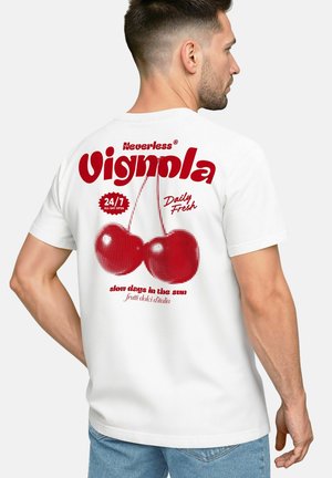 White t-shirt featuring a red graphic of cherries and retro text on the back. The design includes bold lettering and a dotted pattern.