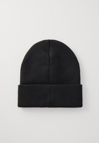 Black knitted beanie with a folded cuff. Soft texture, rounded top, and seam detailing on the side. Simple, monochromatic design.