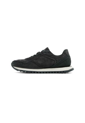 Black suede athletic shoe with a round toe, lace-up closure, and a white midsole. Features textured accents and a ridged rubber outsole.